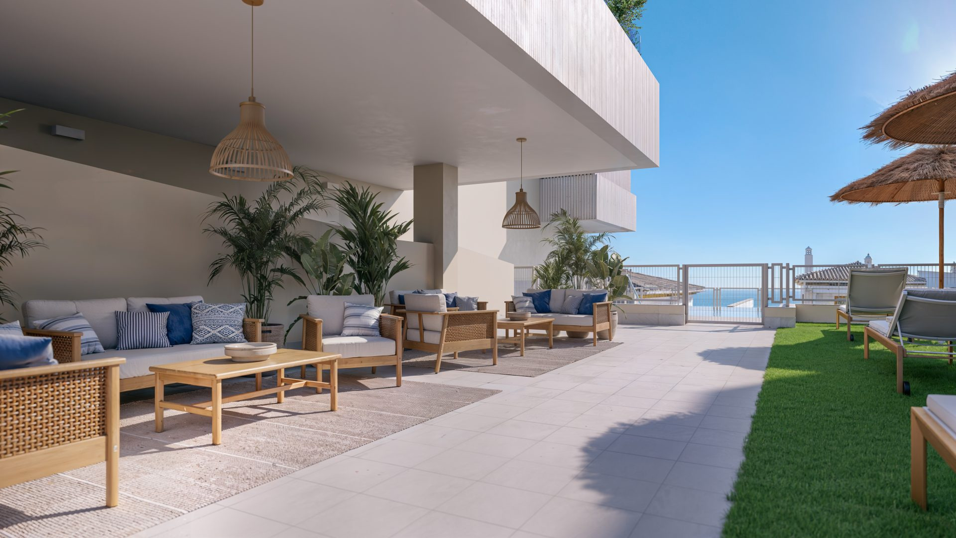 Zona de estar exterior con sofás de fibra natural abierta al mar