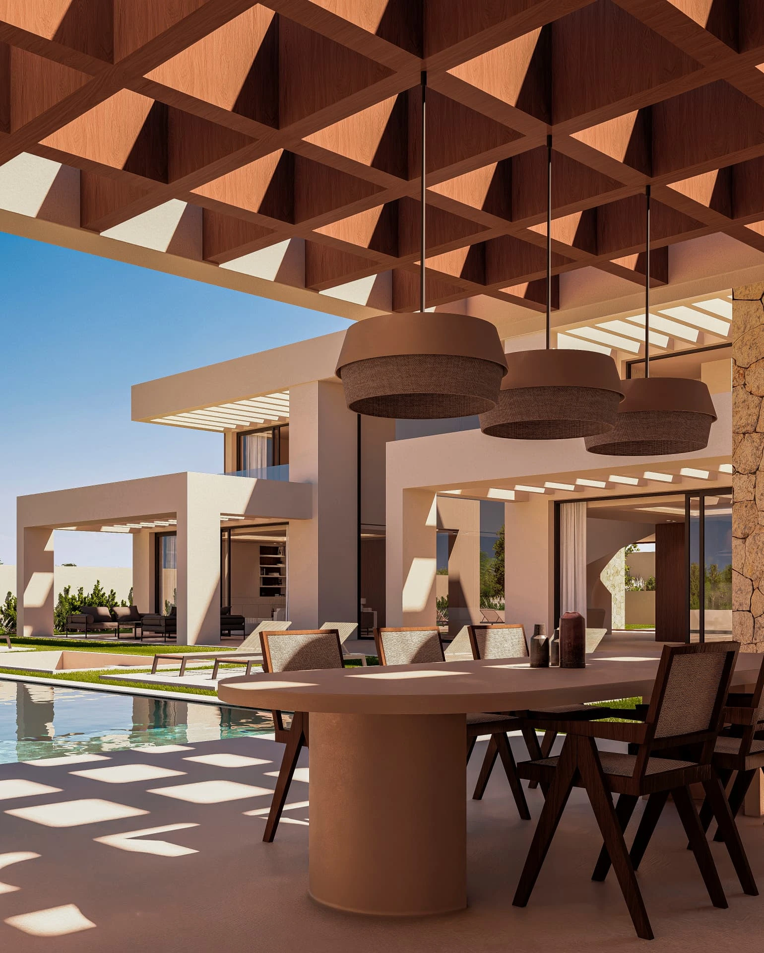 Comedor exterior bajo pérgola junto a la piscina