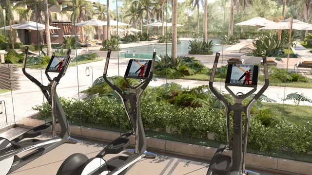Gimnasio con vistas a la piscina y los jardines
